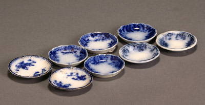 Group of Eight Flow Blue Butter Pats: Group of Eight Flow Blue Butter Pats Consisting of three 'Brooklyn', two by New Wharf pottery, two possibly 'Marechal Niel' and one unidentified. Four with chips; one with crack. Diameter of each