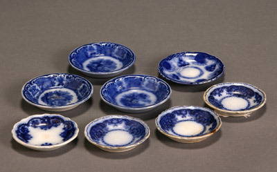 Group of Eight Flow Blue Butter Pats: Group of Eight Flow Blue Butter Pats Consisting of three 'Florida', one 'Baltic', one possibly 'Clarence', and three with Arabian landscape. Approximate diameter: 3 in