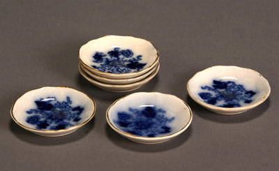 Set of Six Flow Blue Butter Pats: Set of Six Flow Blue Butter Pats One with chip to rim. Diameter: 3 in