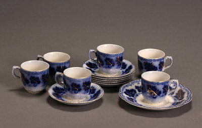 Set of Six Johnson Bros. Flow Blue 'Normandy' Demit: Set of Six Johnson Bros. Flow Blue 'Normandy' Demitasse Cups and Saucers and a Saucer Crack to large saucer. Height of cups: 2-1/4 in; Diameter of saucers: 4-1/2 in