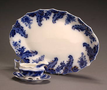 W. H. Grindley Flow Blue 'Argyle' Platter and a Gra: W. H. Grindley Flow Blue 'Argyle' Platter and a Gravy Boat with Undertray Chip to gravy boat; repaired crack to undertray. Length of platter: 21 in; Length of gravy boat: 8-5/8 in