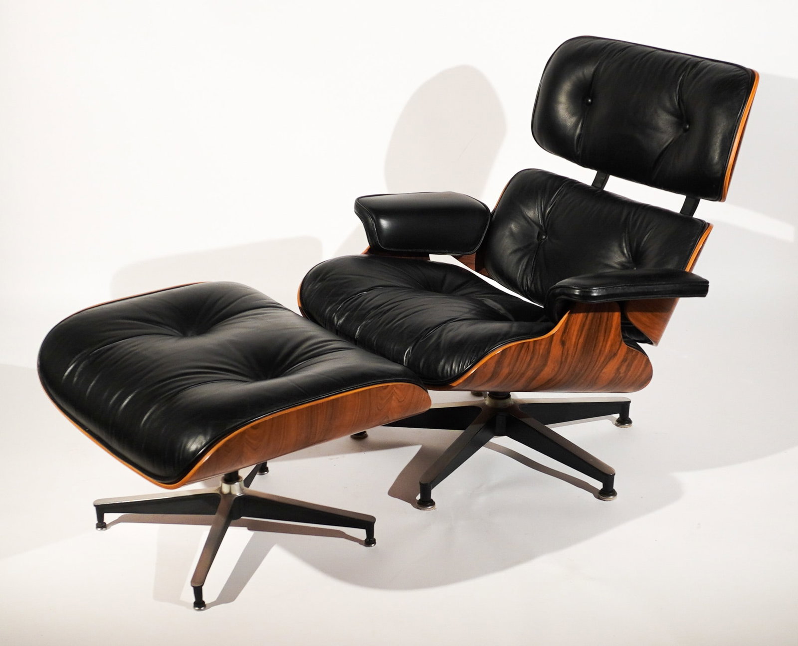 Charles (1907-1978) and Ray (1912-1988) Eames Lounge Chair and Ottoman, Design for Herman Miller,: Charles (1907-1978) and Ray (1912-1988) Eames Lounge Chair and OttomanDesign for Herman Miller, Models 670 and 671, Introduced 1956, Circa 1999Black leather upholstered teak laminate and powder-coated