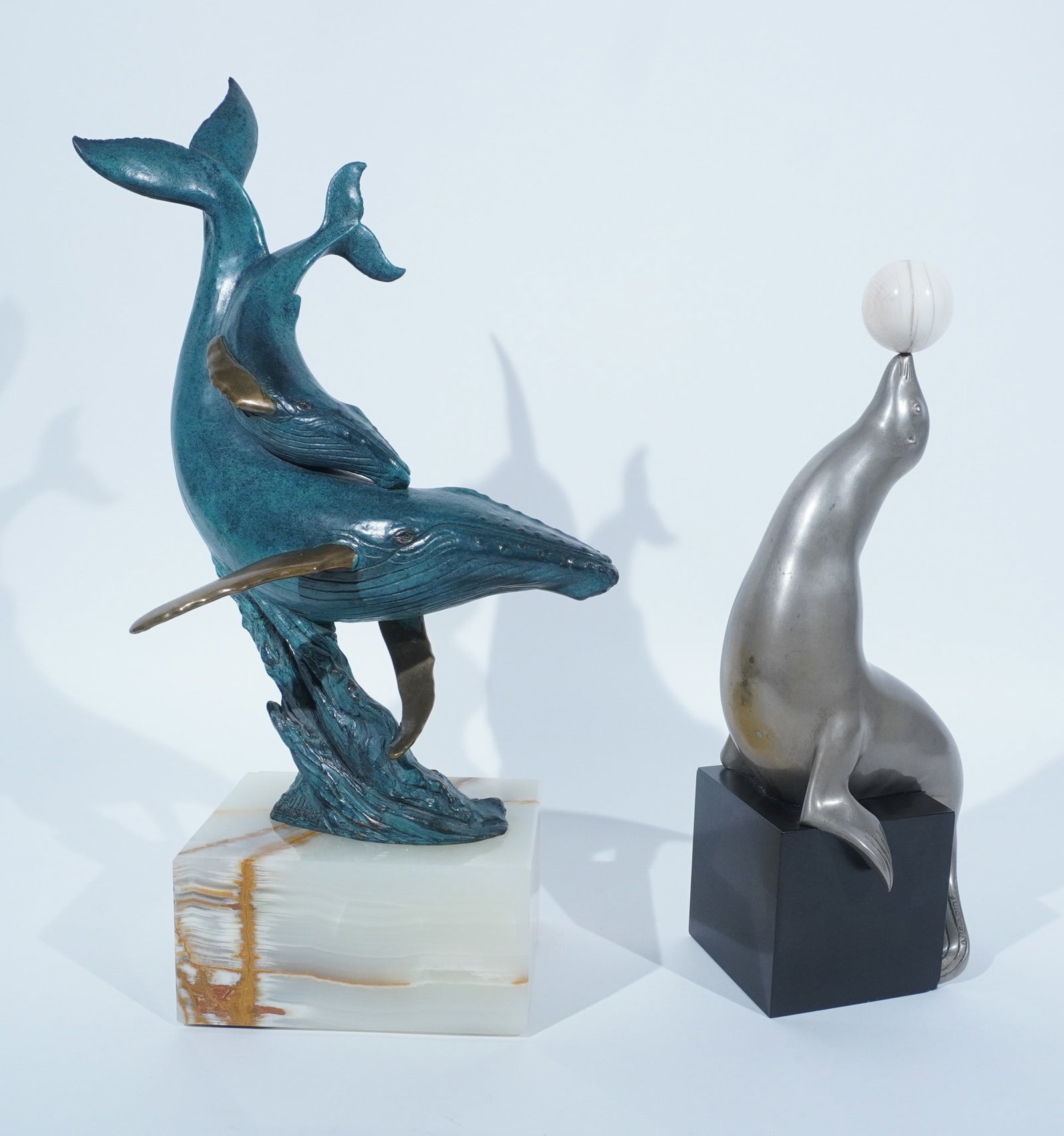 Marcel-André Bouraine (French 1886-1948), Acrobatic Seal Balancing a Ball, together with a Kent: Marcel-André Bouraine (French, 1886-1948) Acrobatic Seal Balancing a Ball Bronze sculpture with grayish-silver patina Signed on tail A Bouraine, on a black slate cube base; together with a Kent U