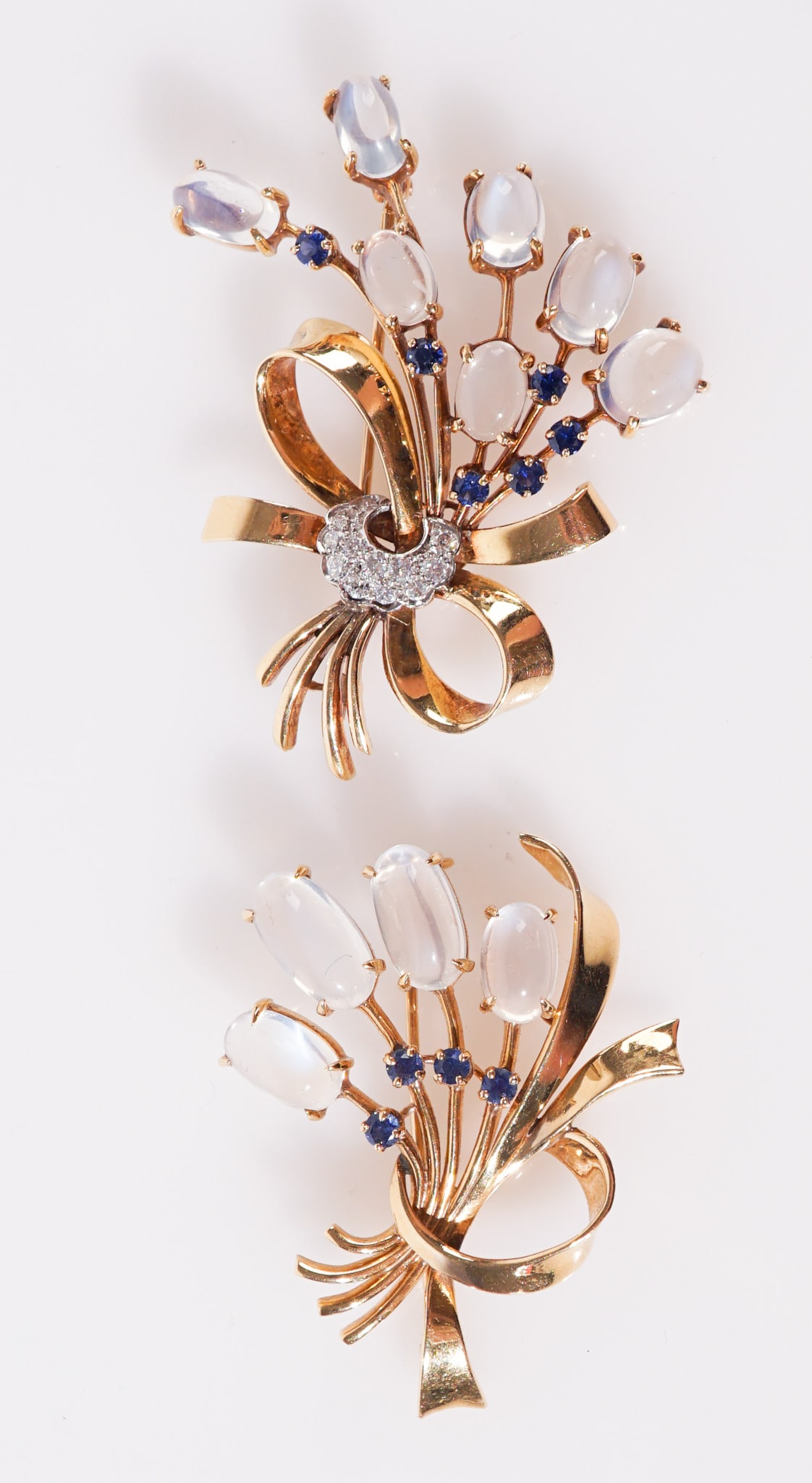 Two Raymond Yard 18-Karat Yellow-Gold, Moonstone, Diamond and Blue Sapphire Brooches, Total gross: Two Raymond Yard 18-Karat Yellow-Gold, Moonstone, Diamond and Blue Sapphire BroochesEach having a bouquet design: the larger, having seven oval cabochon moonstones, six round faceted blue sapphires an