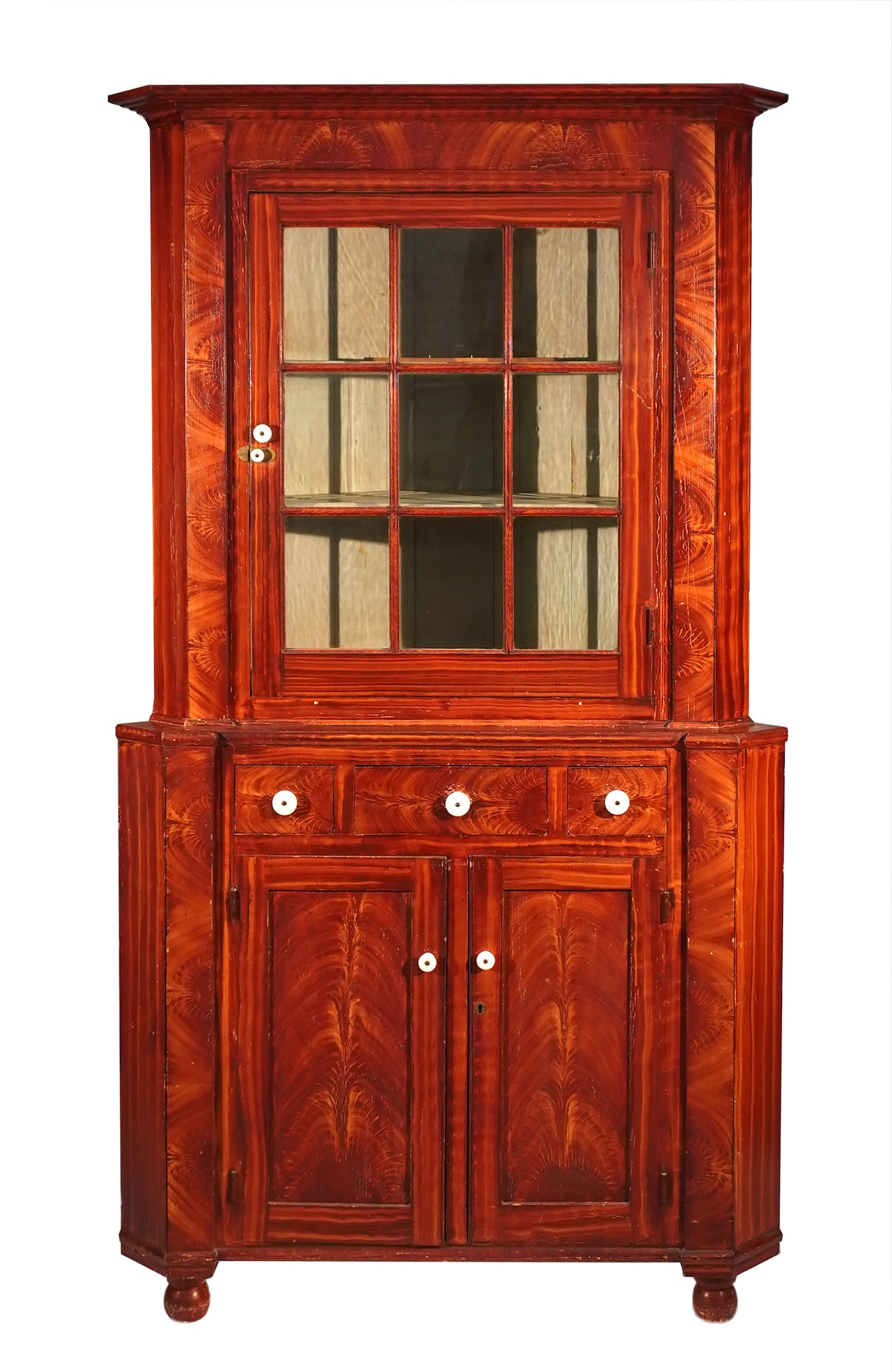 American Grain Painted Pine and Poplar Corner Cupboard, Attributed to John Rupp, Hanover,: American Grain Painted Pine and Poplar Corner CupboardAttributed to John Rupp, Hanover, Pennsylvania, 1830-1850In two parts: the upper section having a window-glazed panel door enclosing a light-green
