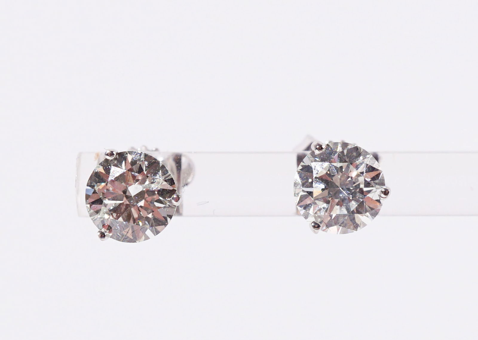 Pair of 14-Karat White-Gold Diamond Stud Pierced Earrings, Total weight of diamonds: 2.10 carats: Pair of 14-Karat White-Gold Diamond Stud Pierced EarringsEach set with one round brilliant-cut diamond weighing approximately 1.05 carats.Total weight of diamonds: 2.10 carats