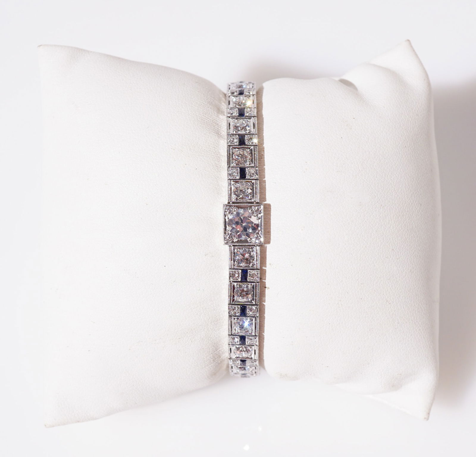 Art Deco Platinum, Blue Sapphire and Diamond Bracelet, Total weight of diamonds: 12 carats, Gross: Art Deco Platinum, Blue Sapphire and Diamond BraceletCirca 1930 Centered with one round old European-cut diamond weighing approximately 1 carat, flanked by seventy-one round old European-cut diamonds