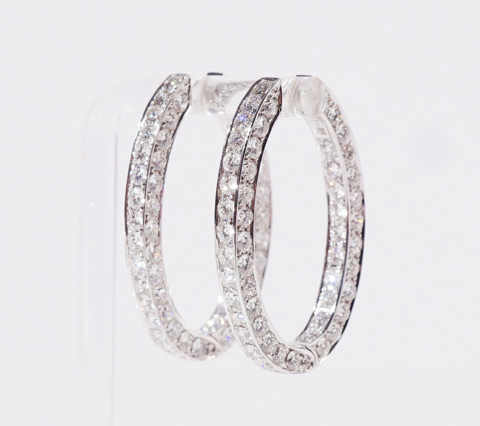 Pair of 18-Karat White-Gold and Diamond Oval Hoop Pierced Earrings, Total weight of diamonds: 12: Pair of 18-Karat White-Gold and Diamond Oval Hoop Pierced EarringsEach inside-out design set with eighty-two round brilliant-cut diamonds weighing approximately 6 carats.Total weight of diamonds: 12 c