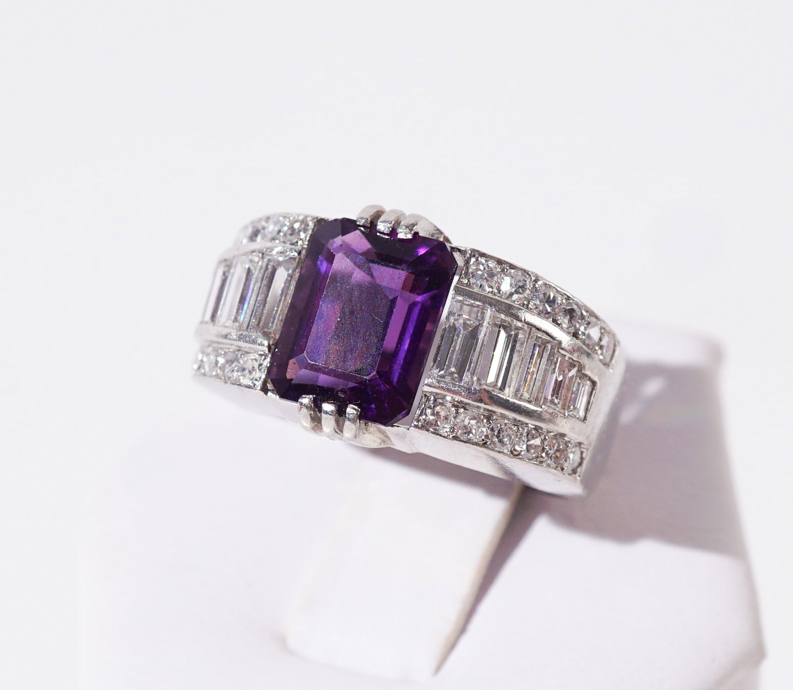 Platinum, Amethyst and Diamond Ring, Gross weight: 8.7 dwt., Shank size: 6-1/2: Platinum, Amethyst and Diamond Ring Centered with one emerald-cut amethyst weighing approximately 3 carats, flanked by ten baguette-cut and twenty-four full-cut diamonds weighing approximately .85 car