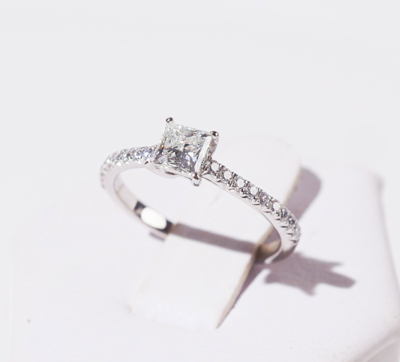 Tiffany & Co. Platinum and Diamond Ring, Total weight of diamonds: .82 carats, Shank size: 5-3/4: Tiffany & Co. Platinum and Diamond Ring Set with one square modified brilliant-cut diamond weighing .52 carats, the shoulders set with twenty round brilliant-cut diamonds weighing approximately .30 ca
