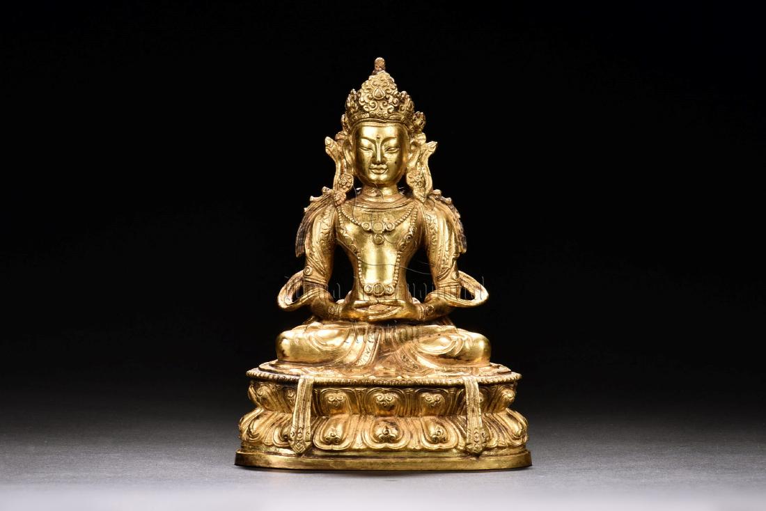 GILT BRONZE SEATED AVALOKITESHVARA FIGURE: The gilt bronze figure depicts Avalokiteshvara seated on double lotus throne, hands in dhyana mudra, wearing ornate cloth with patterns, eyes open, bottom bears vajra mark. Height: 7 in (17.8 cm) Widt