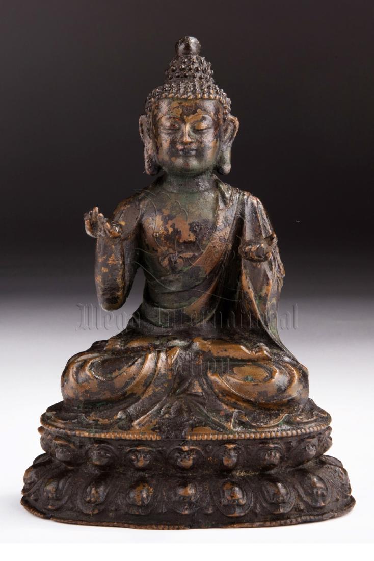 BRONZE CAST SHAKYAMUNI FIGURE: Well cast from bronze, the figure depicts Shakyamuni seated in dhyanasana on top of double lotus throne, two hands lifted with palms up, eyes closed with serene expression. Height: 7 5/8 in (19.4 cm) 