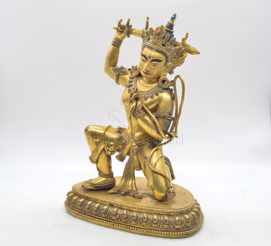 GILT BRONZE CAST THOUSAND-ARMS BODHISATTVA: The gilt bronze Bodhisattva has many heads, arms, and legs, standing on groups of men on top of lotus throne pad with a cohort in the front, the Bodhisattva's arms spread widely in front of flaming ma