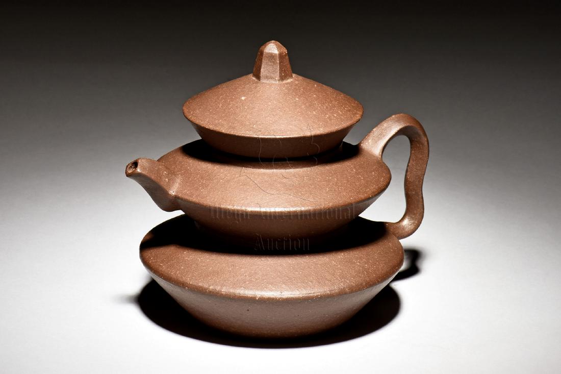 YIXING ZISHA 'PAGODA' TEAPOT: The Yixing Zisha stoneware teapot is of pagoda form with three tiered layers, with angular spout, handle, and finial on top, the clay is of dark brown color tone, the bottom bears four character mark.