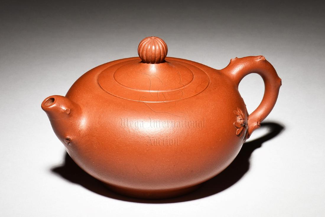YIXING ZISHA 'FLOWERS' TEAPOT: The Yixing Zisha stoneware teapot is of bulbous form, the body depicts flowers, vines, and branches, the clay is of orange color tone, and the teapot has a total of four artist marks on the bottom, ha