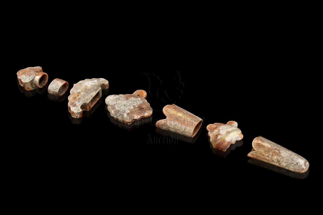 A SET OF SEVEN JADE CARVED SWORD ORNAMENTS (1 of 18)