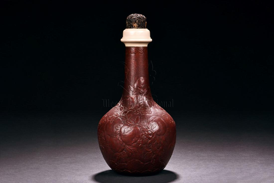 CARVED GOURD BOTTLE VASE: Of globular form with long and thin neck, the bottle vase made from gourd, the surface carved with peaches, flowers, and vines, all above lappet patterns, the lid made from a combination of bone and t