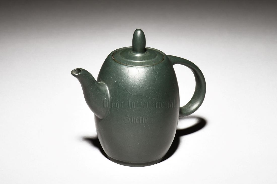 YIXING ZISHA GREEN CLAY TEAPOT: The Yixing Zisha stoneware teapot is of ovoid form, the body has elegant spout and handle on the sides, with raised ovoid finial on top of ring patterned lid, the clay is of green color tone, and the 