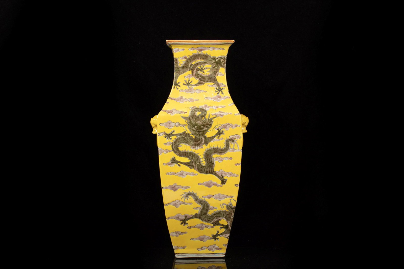 A SQUARE-SECTIONED YELLOW-GROUND FAMILLE VERTE VASE: Height: 17 in (43.2 cm) Width: 7 in (17.8 cm) 清早無款 黃地雲龍紋撇口雙獸耳方瓶