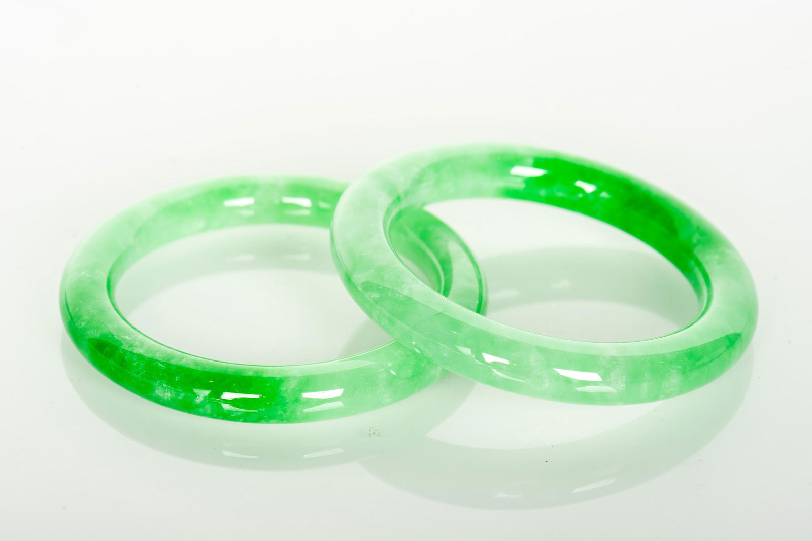 A PAIR OF SUPERB JADEITE BANGLES (1 of 2)