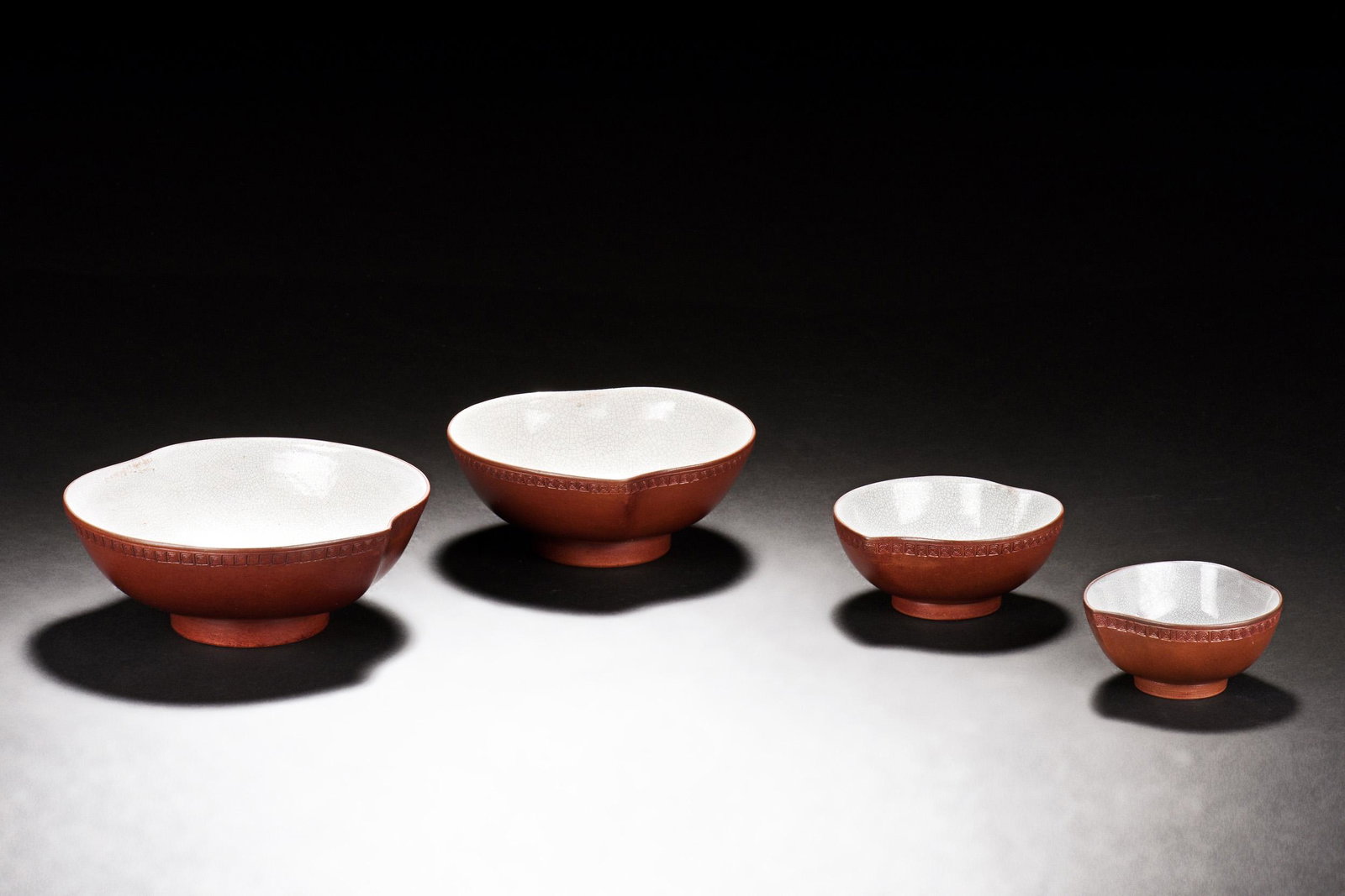 SET OF FOUR YIXING ZISHA BOWLS: 紫砂陶型碗一套四個 The set of four Yixing Zisha bowls each in half-peach form, size ranging from large to small, exterior clay in reddish-brown co