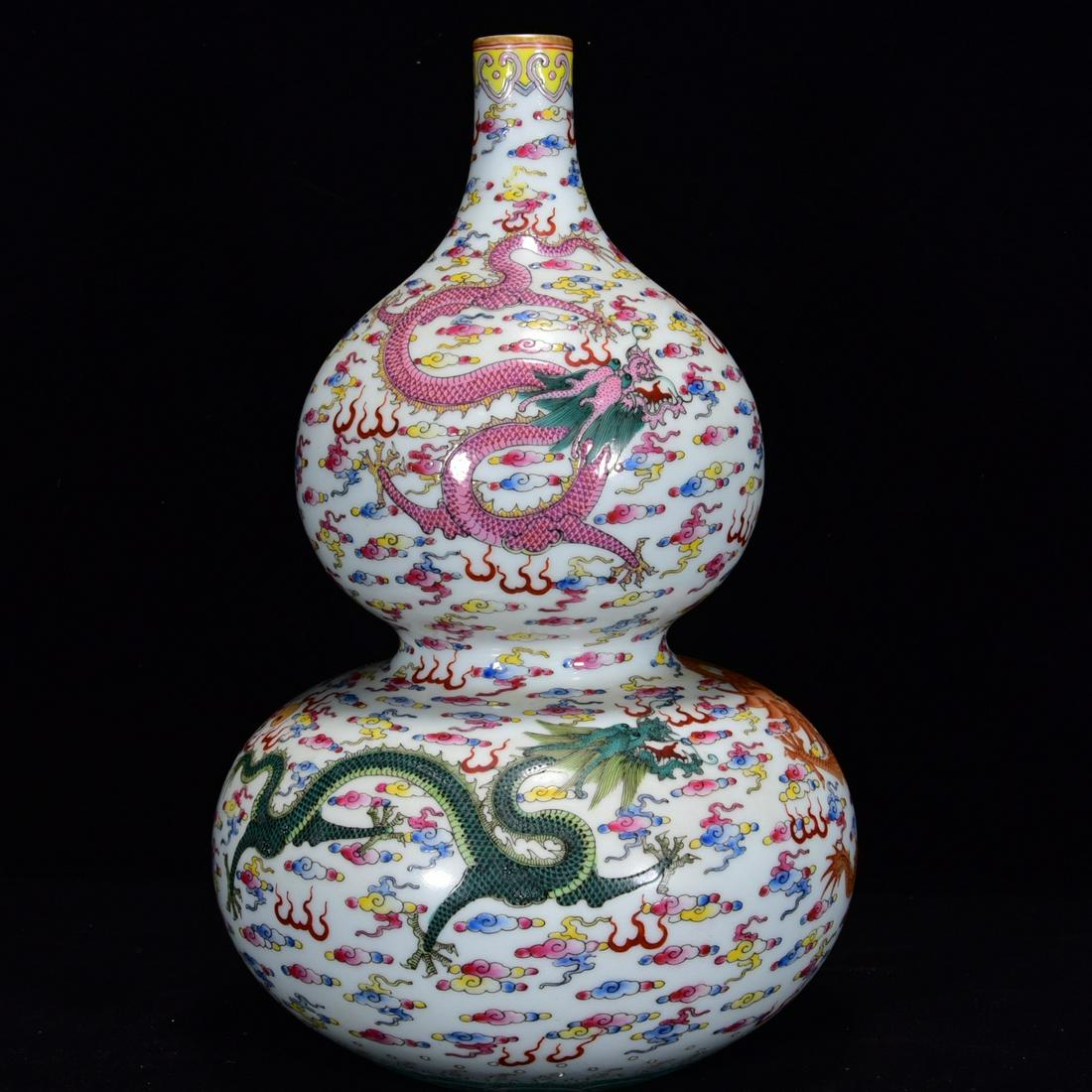 A CHINESE FAMILLE ROSE DRAGON PATTERN PORCELAIN: 清 雍正 粉彩龙纹葫芦 A Chinese Famille Rose Dragon Pattern Porcelain Gourd-shaped Vase Height: 12 2/8 in (31.0 cm) Diameter: 7 7/8 in (20.0 cm)