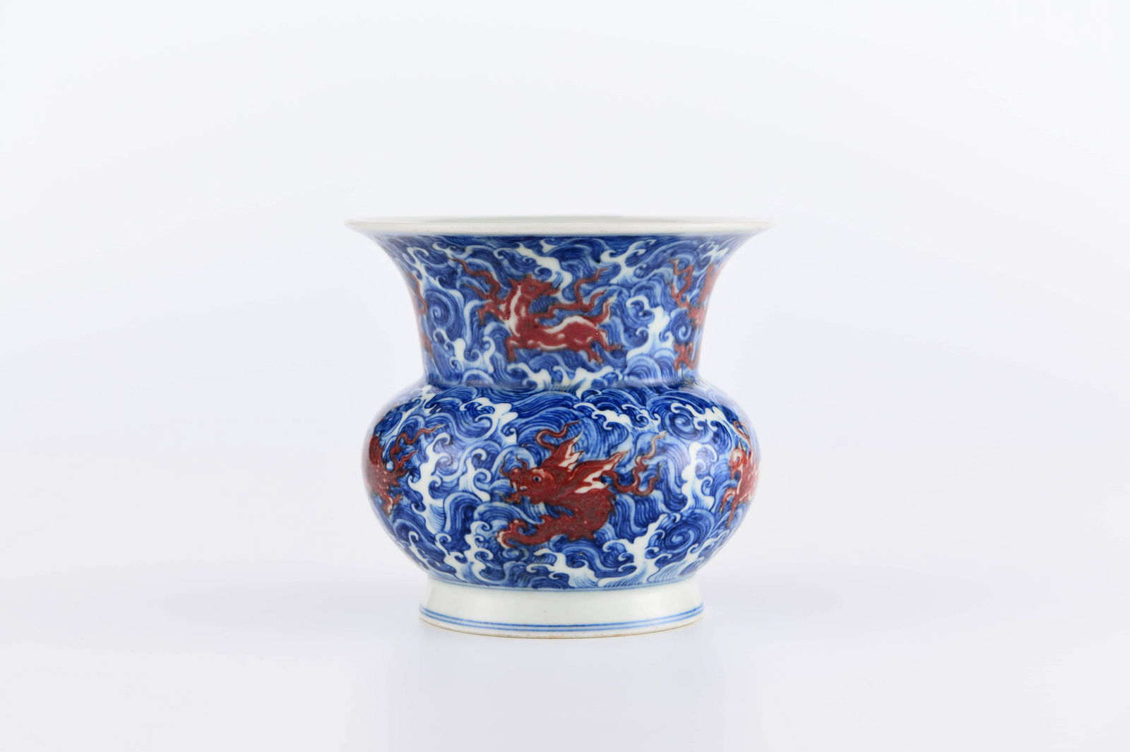 A CHINESE UNDERGLAZED COPPER-RED BLUE AND WHITE: 青花釉里红渣斗 A Chinese Underglazed Copper-Red Blue and White Porcelain Bin Height: 4 3/4 in (12.0 cm) Diameter: 5 1/8 in (13.0 cm)