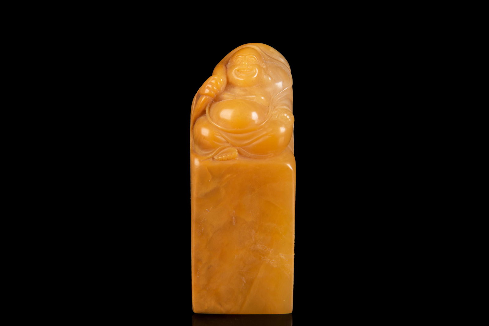 TIANHUANG SOAPSTONE CARVED 'MAITREYA BUDDHA' STAMP SEAL: 彌勒佛田黃印材 The Tianhuang soapstone stamp seal has rounded rectangular base, top mounted with Maitreya Buddha knob, bottom uncarved, the stone retains natu