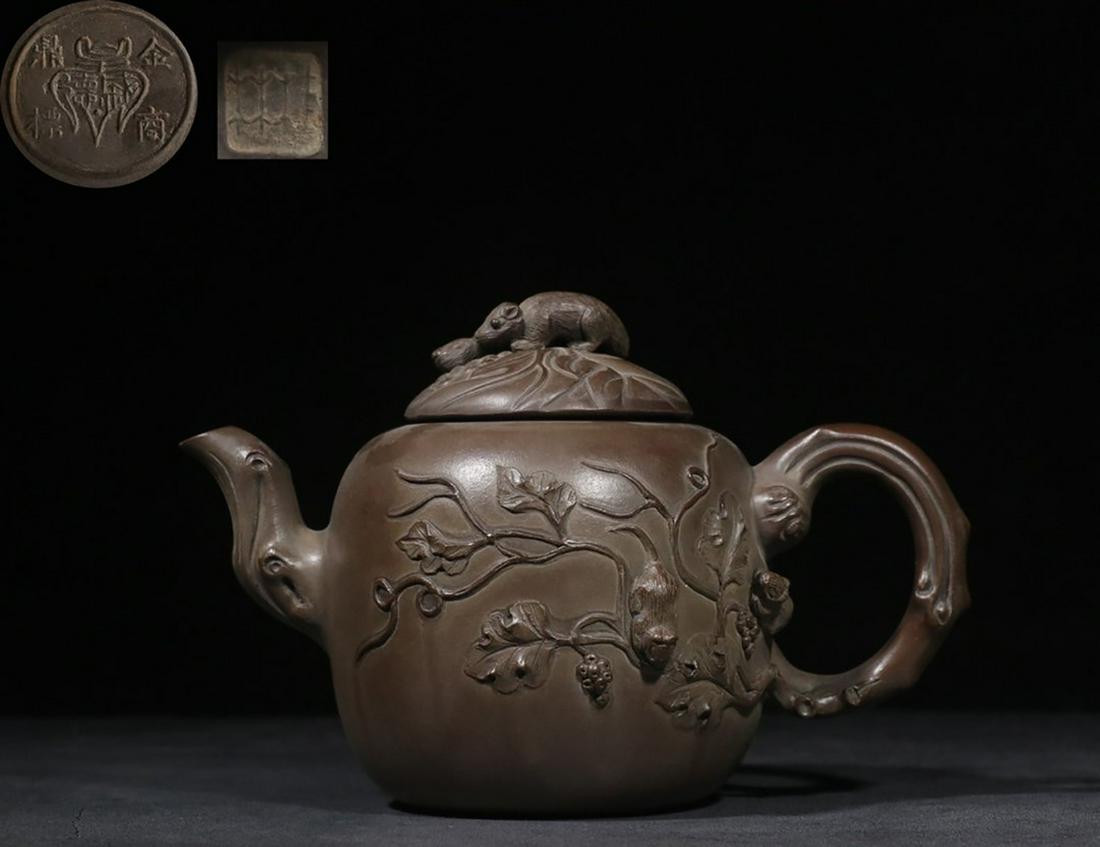 YIXING ZISHA BROWN CLAY CARVED 'SQUIRREL AND GRAPE' TEAPOT: “金鼎商标，桂林”款手工制松鼠葡萄紫砂壶 Yixing Zisha brown clay carved 'Squirrel 