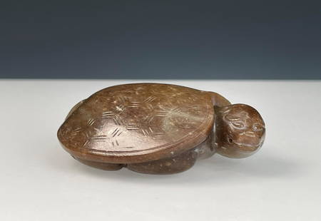 HETIAN JADE CARVED 'TURTLE' ORNAMENT: 和田玉乌龟 Hetian jade carved 'Turtle' ornament Height: 7/8 in (2.5 cm) Length: 2 5/8 in (6.5 cm) Width: 2 1/8 in (5.3 cm)