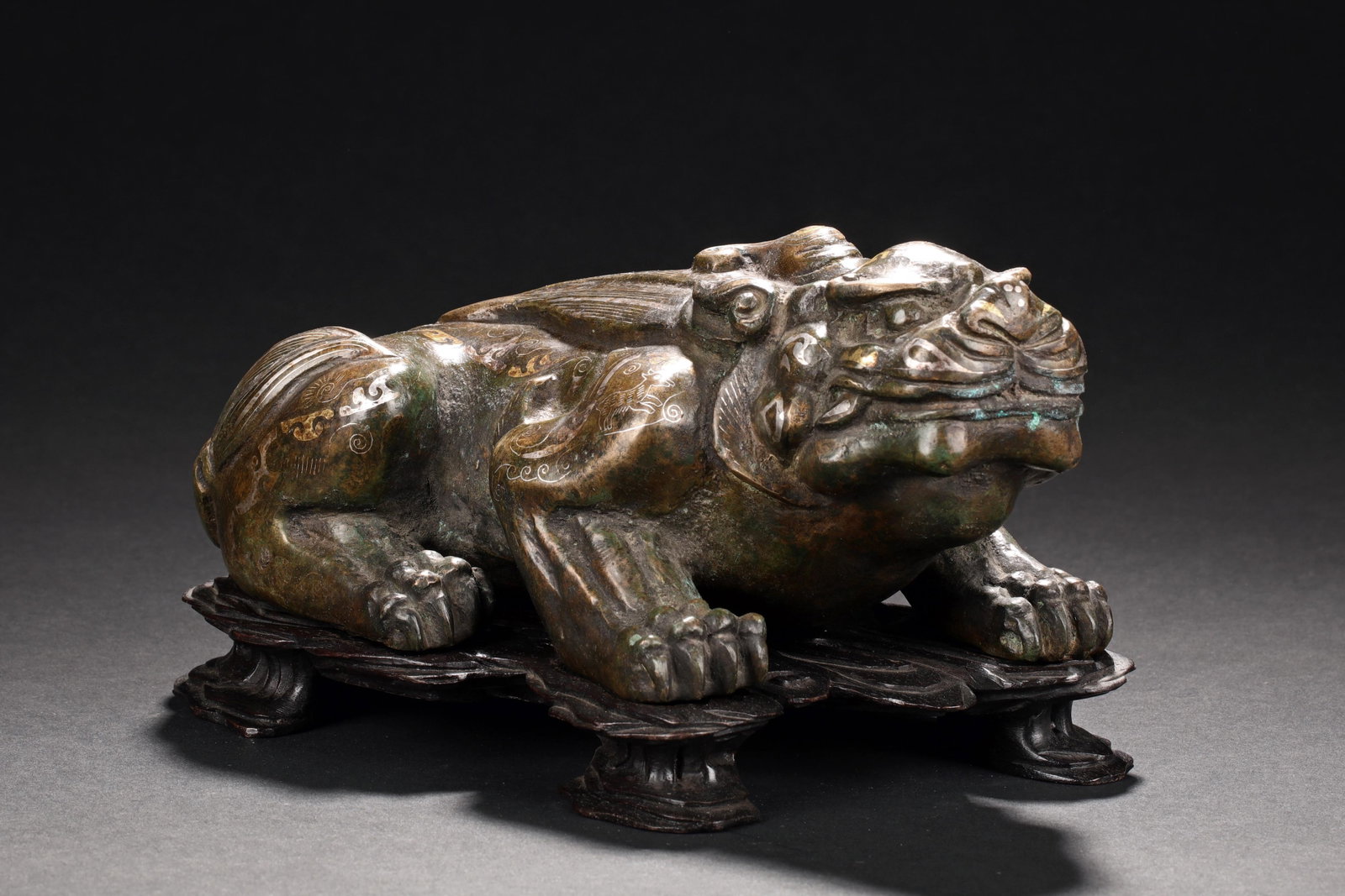 GILT BRONZE 'MYTHICAL BEAST' FIGURE WITH STAND: 仿戰國 錯金錯銀青銅獸 帶紫檀座 The bronze figure gilt on the exterior in gold and silver decorated with animals, pat