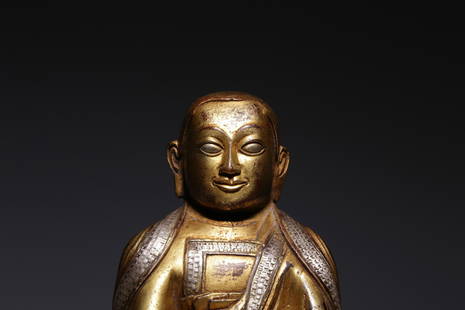 QING DYNASTY GILT BRONZE AND SILVER INLAID STATUE OF THE MASTER: 清代铜鎏金嵌银上师坐像 Qing Dynasty gilt bronze and silver inlaid statue of the master Height: 6 3/4 in (17.0 cm)