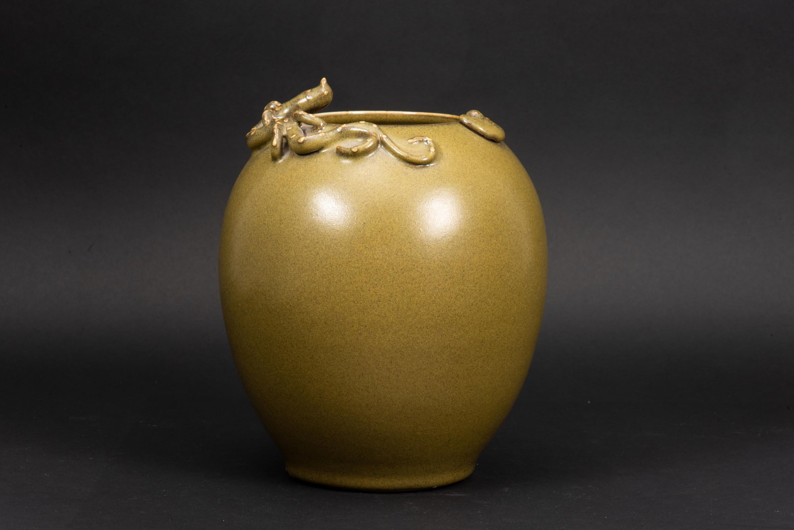 TEA DUST GLAZED 'CHILONG' OLIVE SHAPED TEA JAR: 道光螭龙贴塑茶叶末罐一件 Tea dust glazed 'Chilong' olive shaped tea jar Height: 8 3/8 in (21.0 cm)