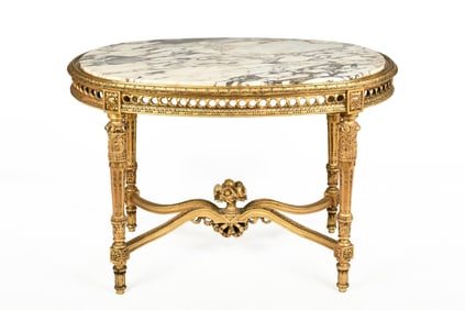 LOUIS XVI GILTWOOD CARVED OVAL SHAPED MARBLE TOP SALON TABLE WITH FLORAL FILLED URN MOUNTED
