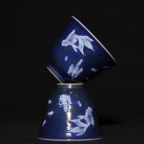 A PAIR OF QING GUANGXU JI BLUE GLAZE CARVED GOLDFISH CUPS