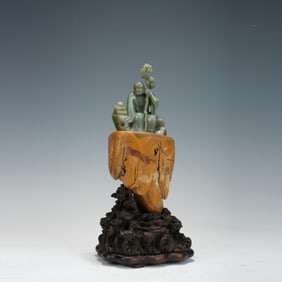 A QING DYNASTY BLUE AND WHITE JADE ARHAT-SHAPED SEATED STATUE