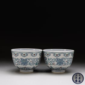 A PAIR OF DOUCAI APRICOT FLOWER AND GANODERMA LUCIDUM CUPS MADE IN THE YONGZHENG PERIOD OF THE QING