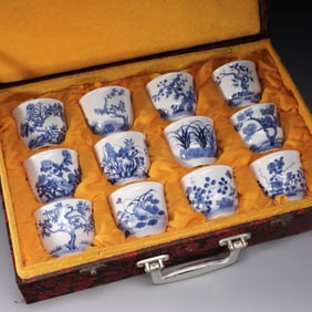 A SET OF BLUE AND WHITE TWELVE FLOWER GOD CUPS