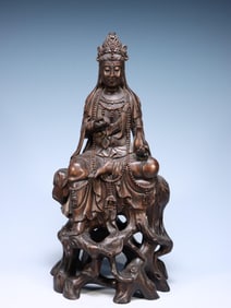 QING. AGARWOOD CARVED GUANYIN SITTING IN A BOTTLE