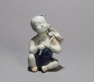 A PORCELAIN FIGURE