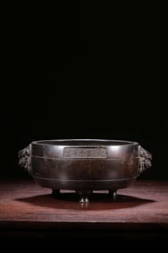 QING DYNASTY "MADE IN XUANDE PERIOD OF THE MING DYNASTY" COPPER DOUBLE LION EARS THREE-LEGGED
