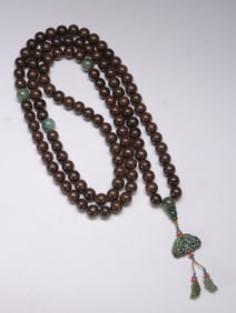 A STRING OF 108 BUDDHAS DECORATED WITH JADE IN AGARWOOD