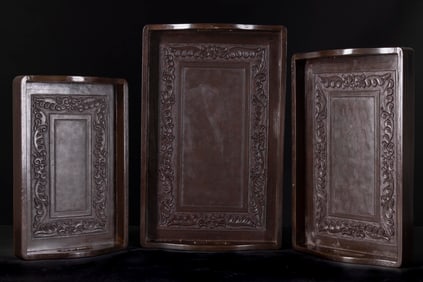 A SET OF THREE WOODEN TRAYS