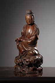 QING DYNASTY YEW CARVED GUANYIN HOLDING SUTRA SEATED FIGURE