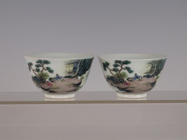 QING YONGZHENG PAIR OF PINK LANDSCAPE AND FIGURE STORY CUPS