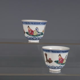 A PAIR OF BLUE AND WHITE POWDER-COLOR BELL-SHAPED CUPS DEPICTING LADIES DURING THE QIANLONG PERIOD