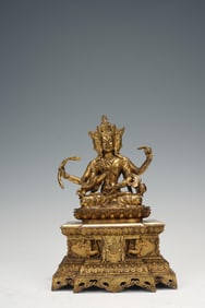 QING DYNASTY GILDED COPPER SIX-ARMED GUANYIN SEATED STATUE