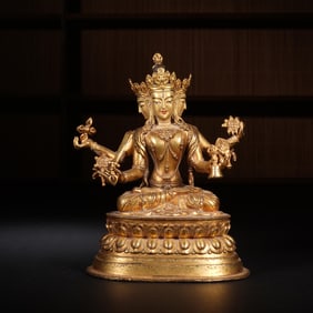 QING DYNASTY COPPER GILT FOUR-ARMED GUANYIN SEATED STATUE