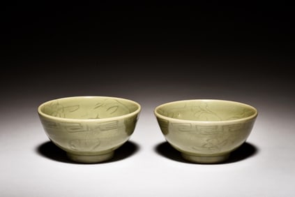 PAIR OF CELADON GLAZED AND CARVED BOWLS