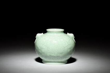 A CARVED CELADON-GLAZED JAR